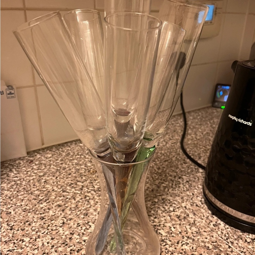 Different colour stem champagne glasses with vase holder